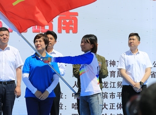 人民網黑龍江頻道外聯部主任趙麗英向運動員代表祁兵授旗