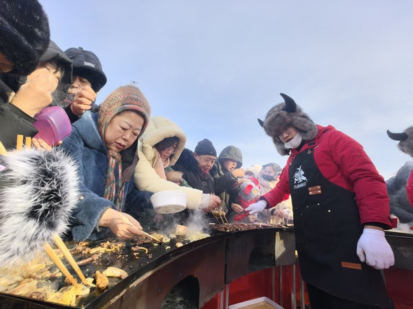 游客品尝鹤城香喷喷的烤肉。