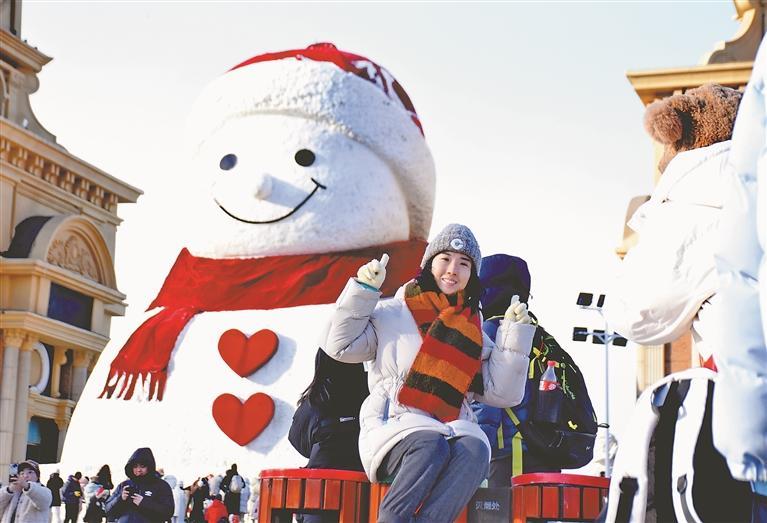 游客打卡哈尔滨网红大雪人。黑龙江日报记者 苏强摄