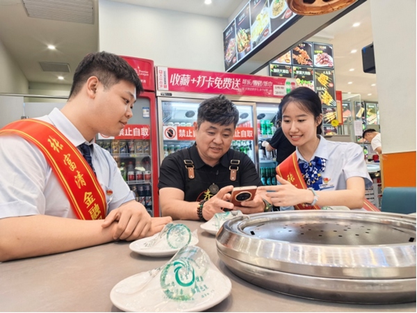 建设银行齐齐哈尔分行“张富清金融服务队”走访和记烧烤店。图片由中国建设银行黑龙江省分行提供