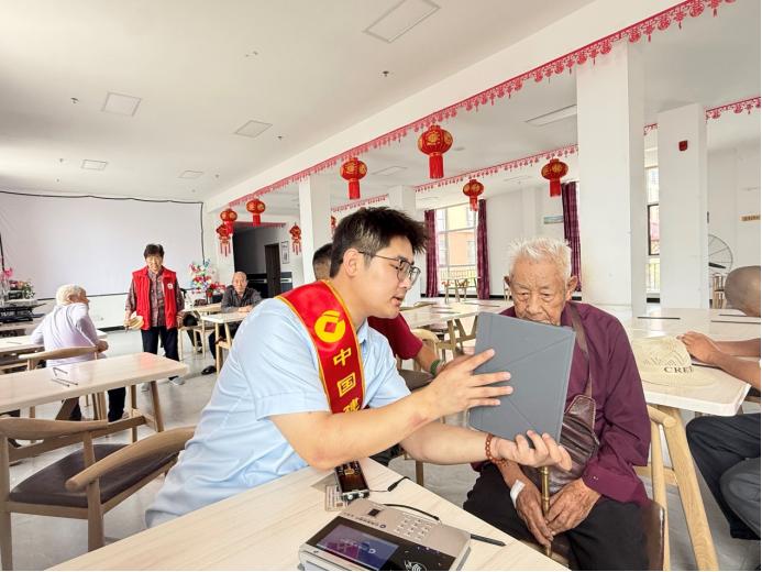 中国建设银行黑龙江省分行工作人员把适老化金融服务送到老年群众身边。图片由中国建设银行黑龙江省分行提供